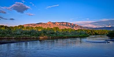 A body of water with trees and a hill in the background

Description automatically generated with low confidence